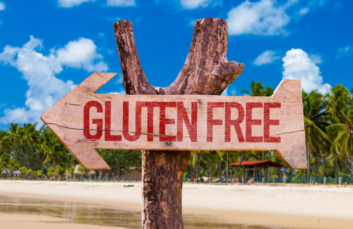Gluten Free arrow with beach background Viaggiare senza Glutine